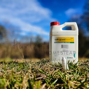A photo of a 5mL bottle of Safe-Guard Aquasol Dewormer and the original 1 Liter bottle